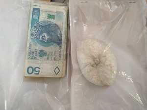 kolorowe zdjęcie - substancja koloru białego oraz banknot 50 złotych