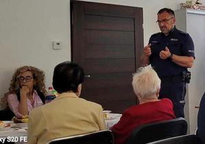 policjant rozmawia z seniorami