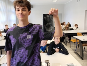 nastolatek z odcisniętą dłonią w tuszu