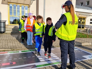 grupa dzieci w odblaskowych kamizelkach