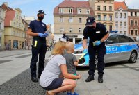 policjanci przekazują ulotki dziecku i jego mamie