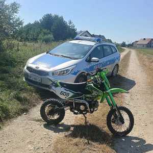 Zdjęcie kolorowe przedstawiające motocykl i radiowóz.