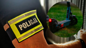 Zdjęcie kolorowe przedstawiające ramię z opaska &quot;Policja&quot; i hulajnogę.