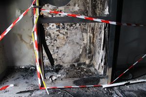 Spalona i zniszczona ściana na klatce schodowej bloku mieszkalnego.