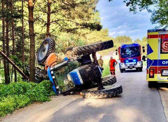 ciągnik rolniczy leżący na boku na jezdni