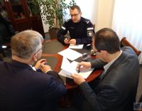 Komendant kluczborskiej policji siedzący w obecności Burmistrza i skarbnika gminy
