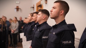 Zdjęcie przedstawia policjantów stojących w szeregu.