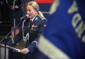 Policjantka przy mównicy.