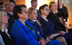 Kobiety siedzą w pierwszym szeregu.