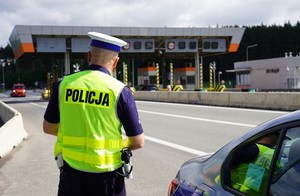 zdjęcie kolorowe: policjant drogówki podczas działań