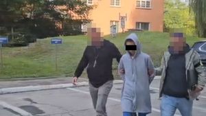 policjanci operacyjni prowadzą zatrzymaną kobietę