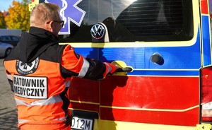 Zdjęcie: ratownik przed drzwiami ambulansu.